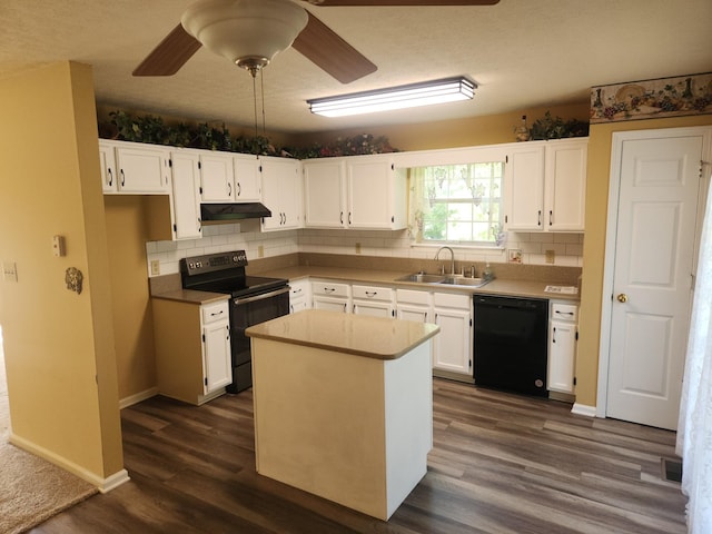 kitchen with black appliances, under cabinet range hood, white cabinetry, and a sink