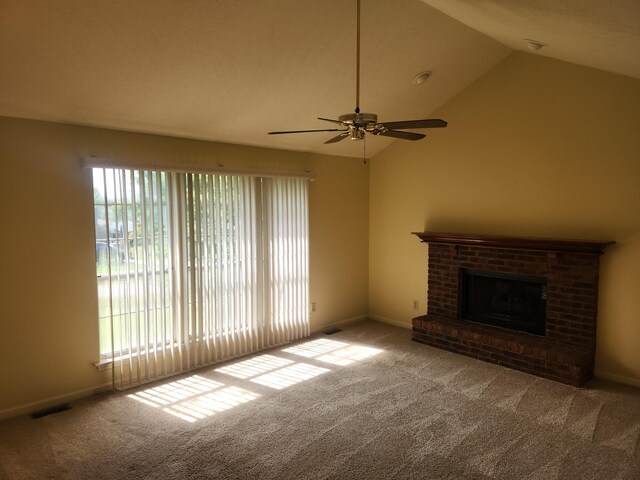 unfurnished living room with a brick fireplace, high vaulted ceiling, light colored carpet, and ceiling fan