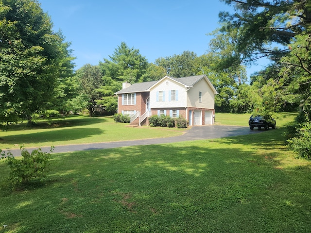 view of front of house with a garage and a front yard