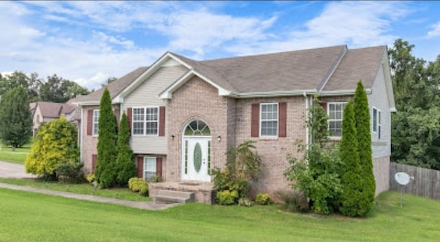 bi-level home with a front lawn