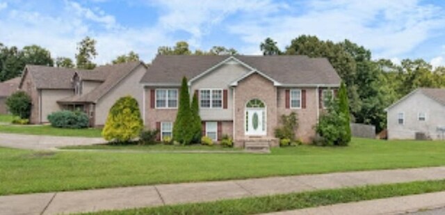 raised ranch with a front yard