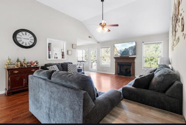 living room featuring lofted ceiling, ceiling fan, a wealth of natural light, and wood-type flooring