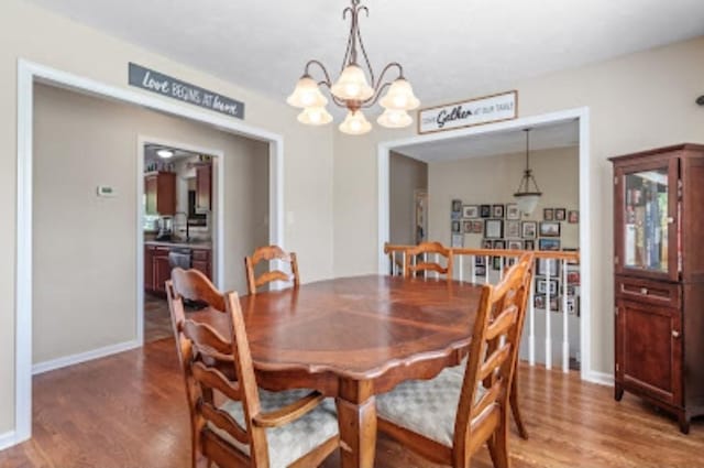 dining room featuring wood-type flooring and a chandelier