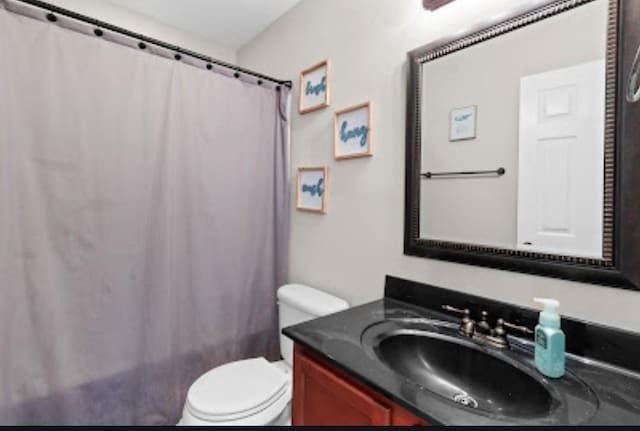 bathroom featuring vanity and toilet