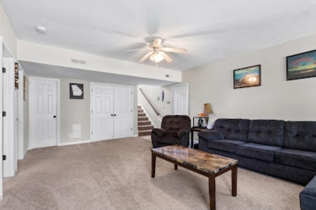 carpeted living room with ceiling fan