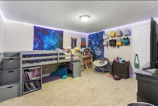 bedroom with a textured ceiling and carpet flooring