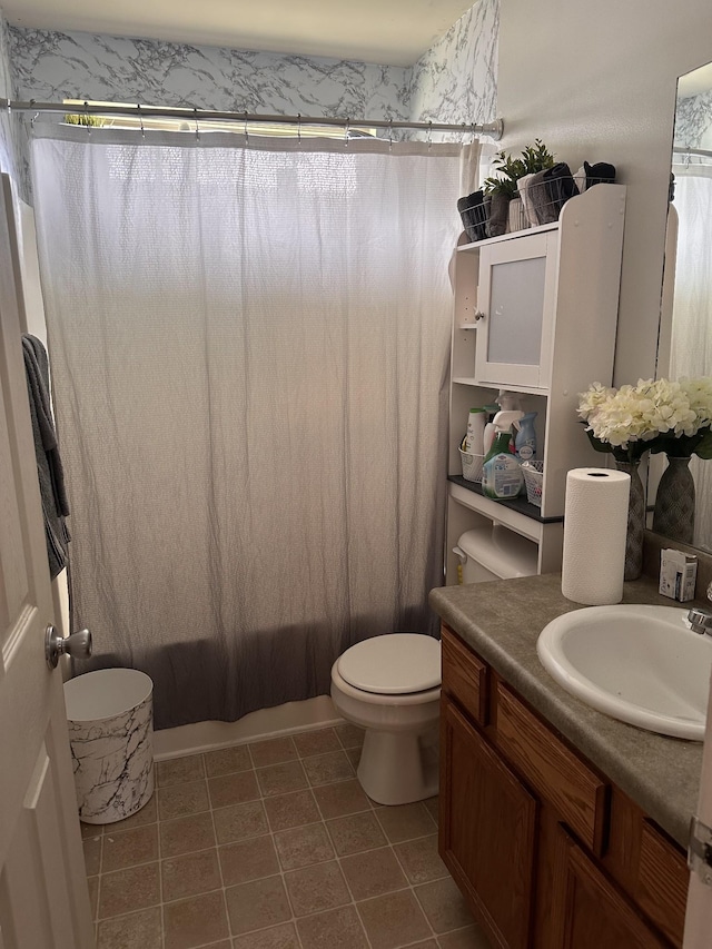 bathroom featuring shower / tub combo, vanity, toilet, and tile patterned floors