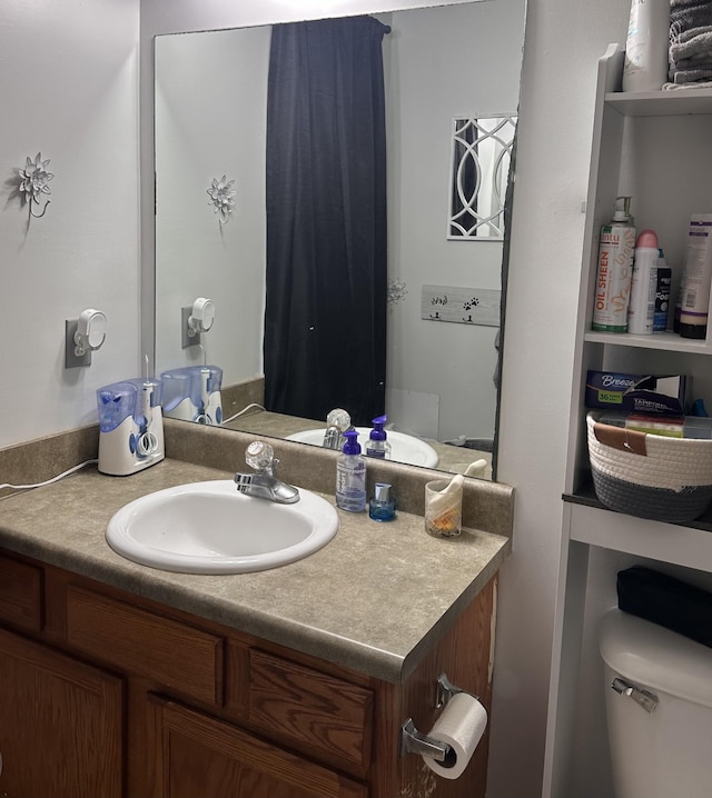 bathroom featuring toilet and vanity