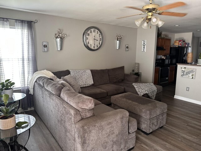 living room with plenty of natural light, dark hardwood / wood-style floors, and ceiling fan