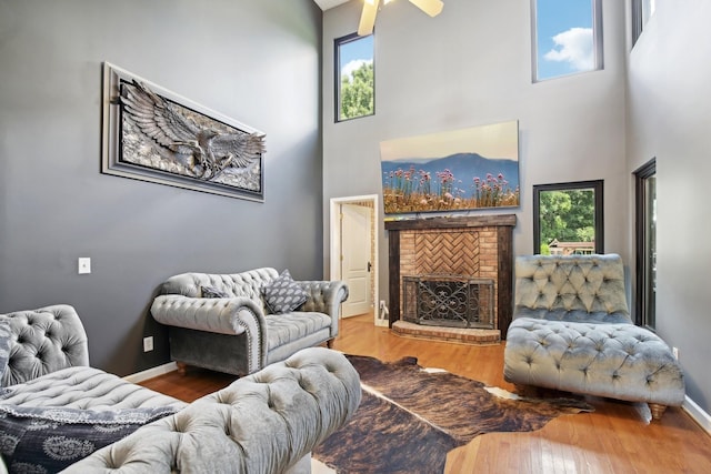 living room with hardwood / wood-style flooring, a healthy amount of sunlight, and a fireplace