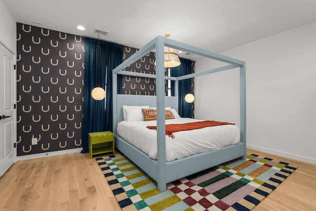 bedroom with wood-type flooring