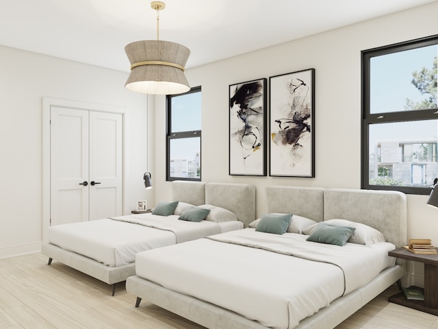 bedroom featuring a closet and light hardwood / wood-style flooring