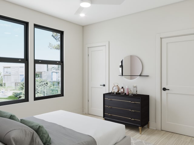 bedroom with ceiling fan and multiple windows