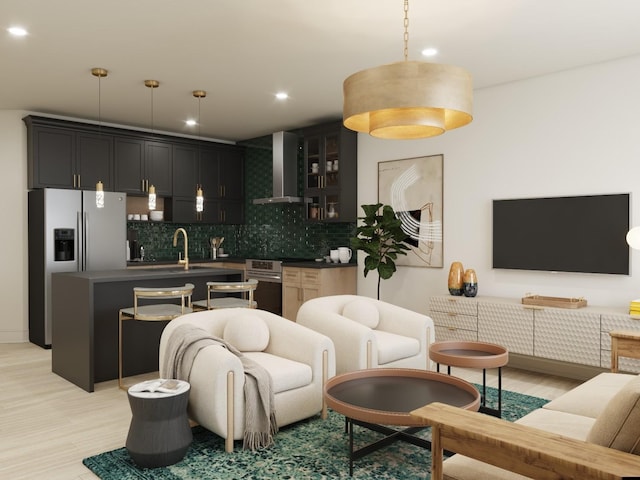 living room featuring sink and light hardwood / wood-style flooring