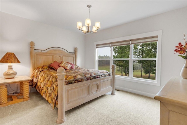 carpeted bedroom featuring a chandelier