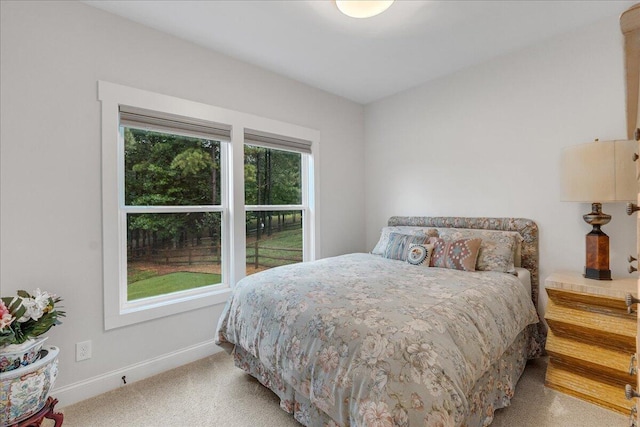 bedroom featuring light carpet