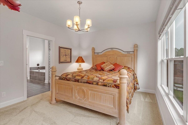 carpeted bedroom featuring an inviting chandelier and connected bathroom