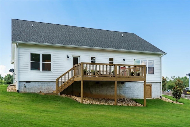 rear view of property with a yard and a deck