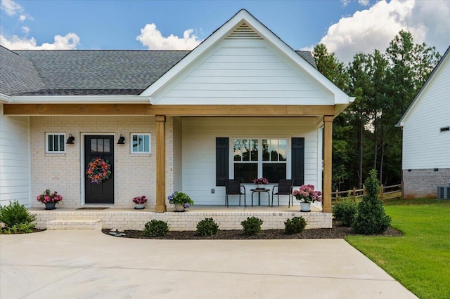 view of front of home featuring cooling unit and a porch