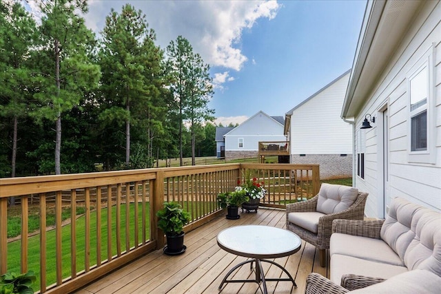 wooden deck featuring an outdoor living space and a yard