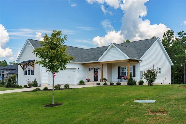 view of front of property featuring covered porch, a garage, driveway, and a front yard