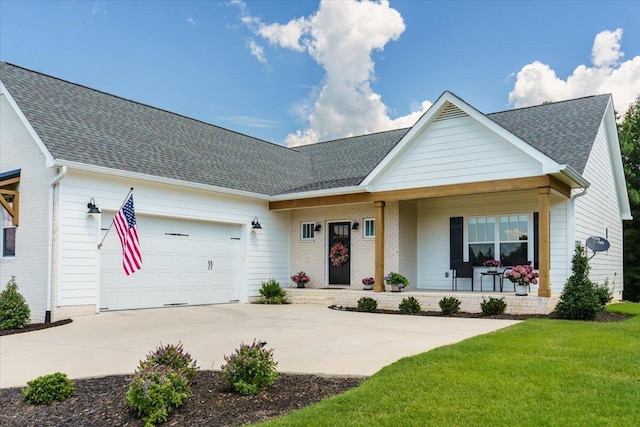 single story home with a porch, a garage, and a front yard