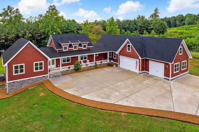 view of front of home with a front yard and a garage