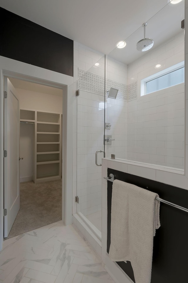 bathroom with a shower with door