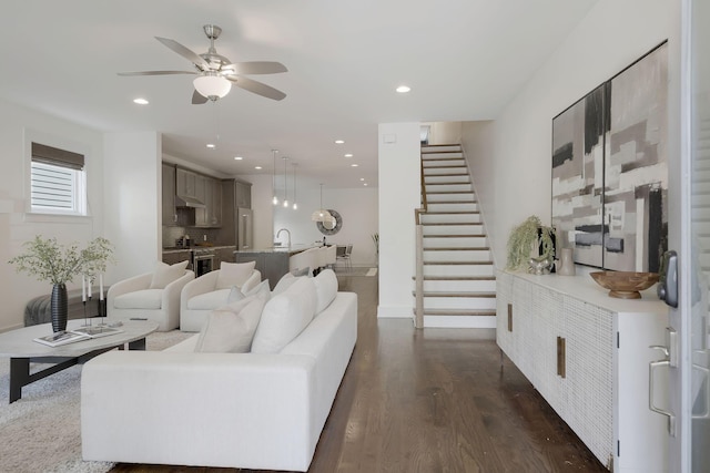 living room with ceiling fan, dark hardwood / wood-style flooring, and sink