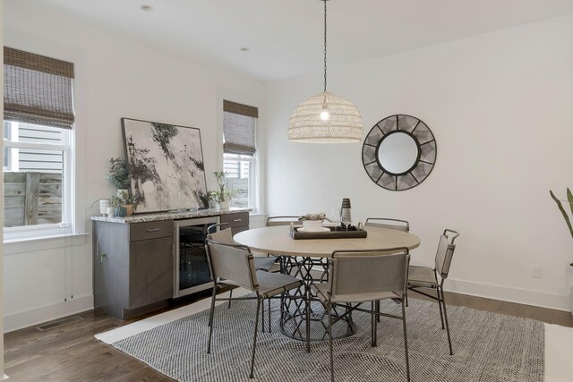 dining room with wine cooler and dark hardwood / wood-style flooring