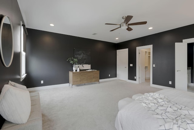 bedroom featuring ceiling fan, light colored carpet, and a spacious closet