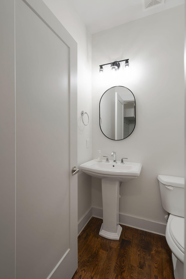 bathroom with sink, hardwood / wood-style flooring, and toilet