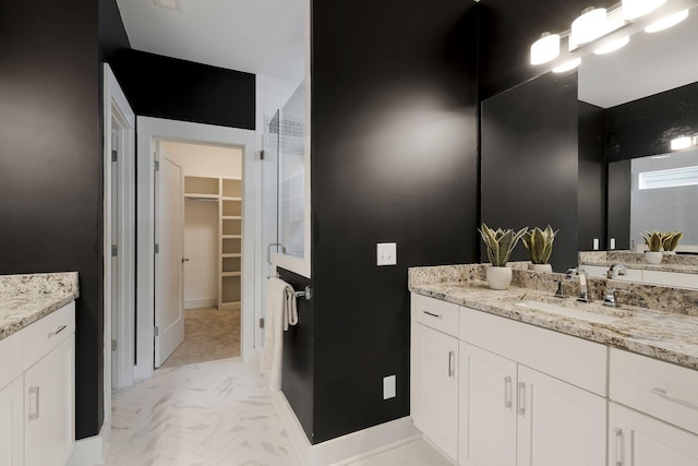 bathroom featuring vanity and an enclosed shower