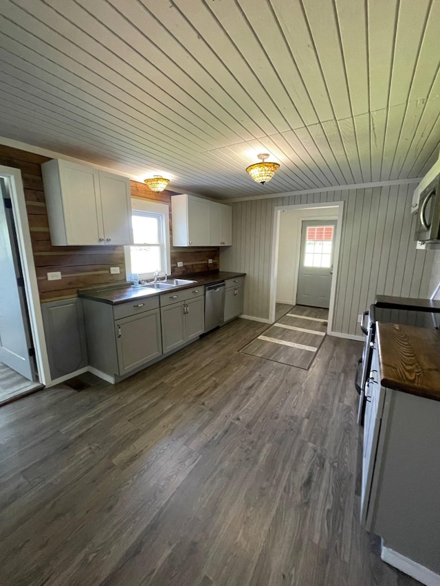 kitchen with dark wood-type flooring, sink, white cabinetry, wood ceiling, and stainless steel appliances