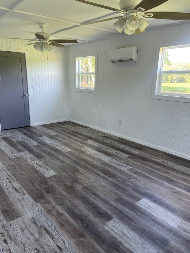 empty room featuring dark hardwood / wood-style flooring, ceiling fan, and a wall mounted AC