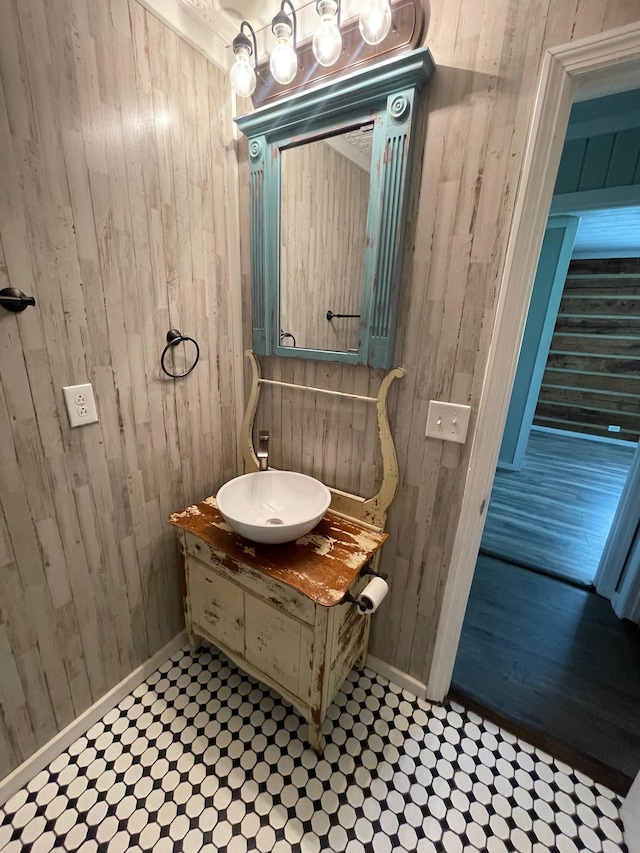 bathroom with vanity and wooden walls