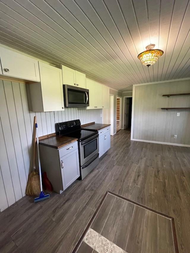 kitchen with white cabinetry, appliances with stainless steel finishes, dark wood-type flooring, and wooden ceiling