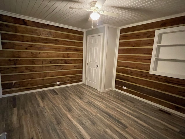 unfurnished bedroom with ceiling fan, wood ceiling, dark hardwood / wood-style flooring, and wood walls