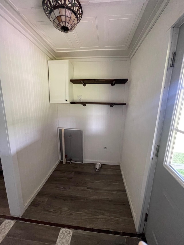 laundry area featuring ornamental molding and dark hardwood / wood-style flooring