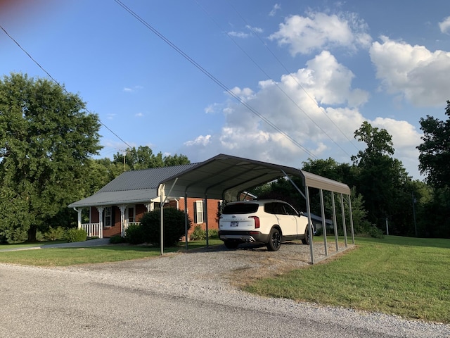 view of parking with a lawn and a carport