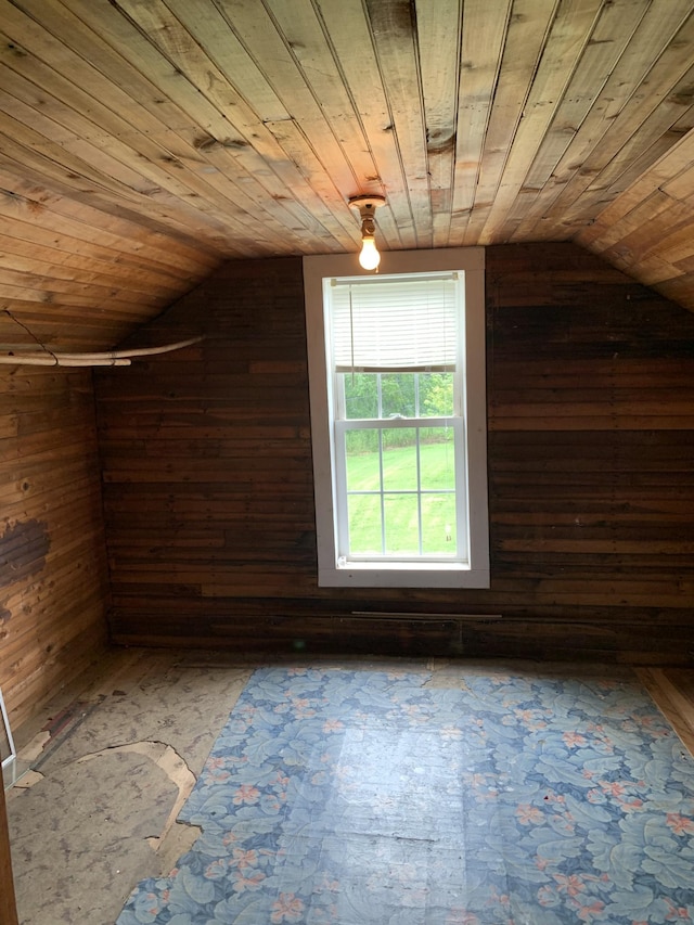 bonus room with vaulted ceiling, wooden ceiling, and wood walls