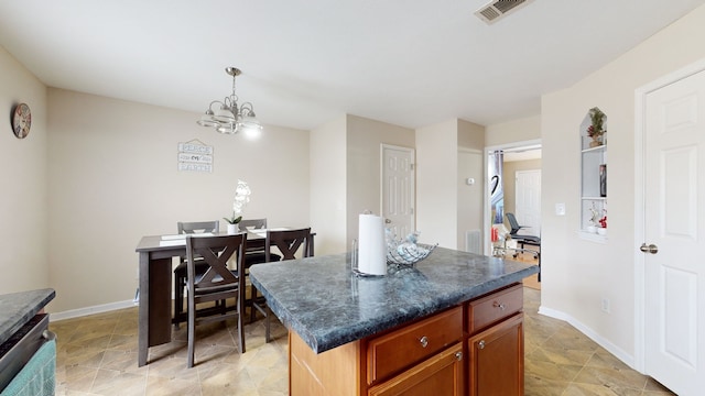 kitchen with a kitchen island, a notable chandelier, and light tile patterned floors