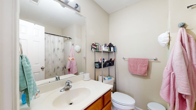 bathroom with toilet and vanity