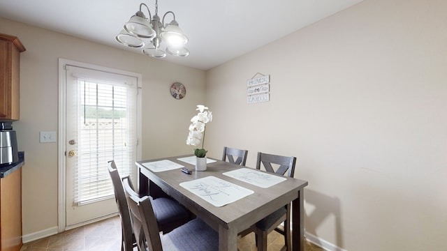 tiled dining room with an inviting chandelier and a healthy amount of sunlight