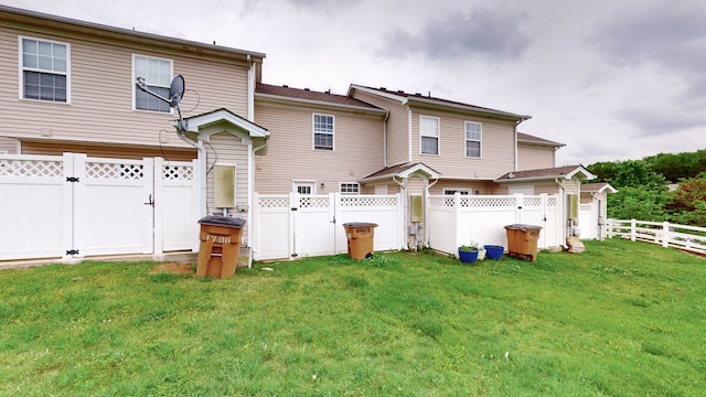 rear view of property with a yard