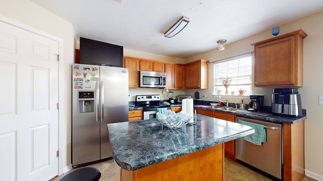 kitchen featuring a kitchen island, stainless steel appliances, and light tile patterned floors