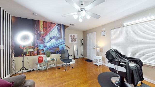 home office with hardwood / wood-style flooring and ceiling fan