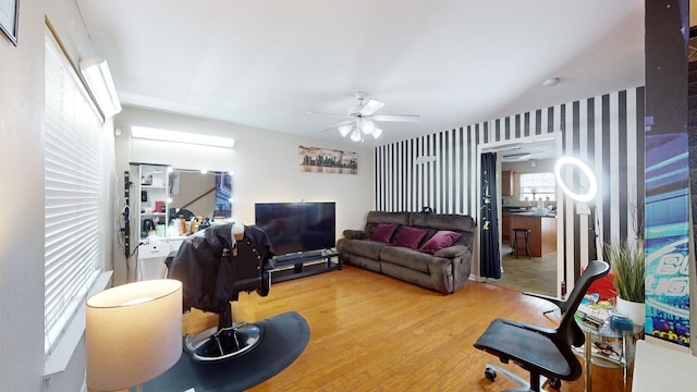 living room featuring light hardwood / wood-style flooring and ceiling fan