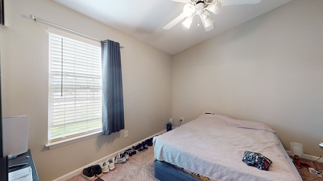 carpeted bedroom featuring lofted ceiling and ceiling fan