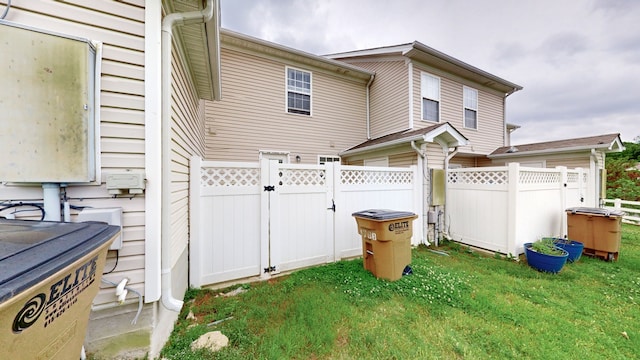 rear view of house featuring a yard